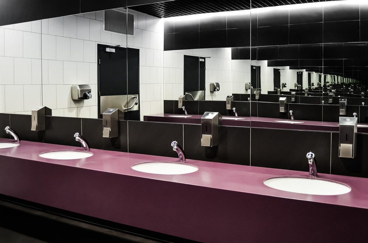 Commercial sanitary ware: row of inset washbasins and sensor taps in a high-traffic washroom