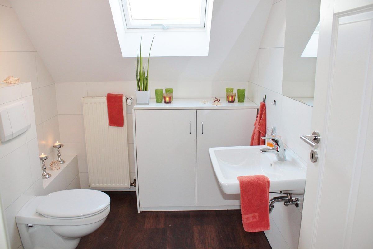 Wall-hung commercial toilet bowl with a concealed cistern and wall-mounted flush plate