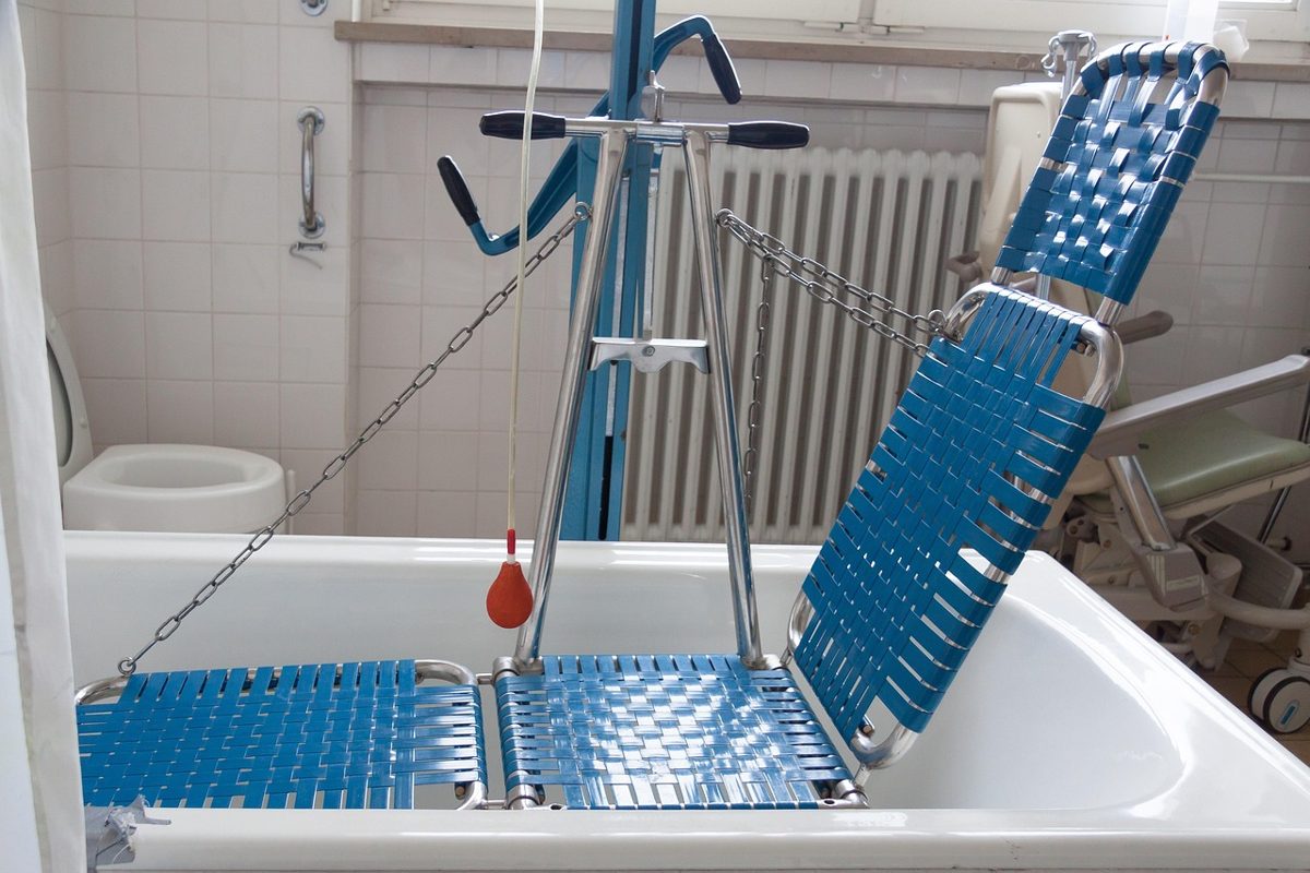 Hoist and support equipment in an accessible bathroom, similar to a Changing Places disabled washroom