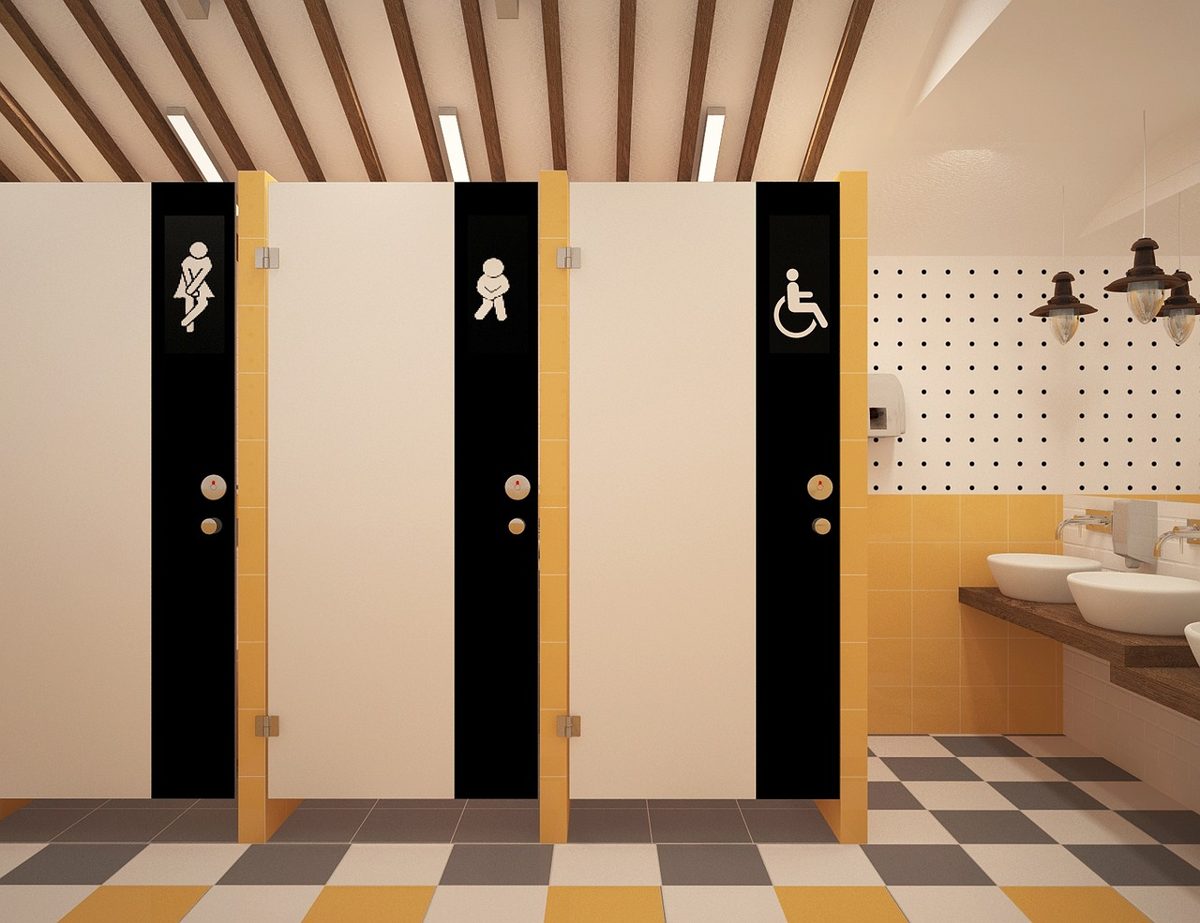 Office washroom with full-height cubicles, an accessible WC and a row of vanity basins